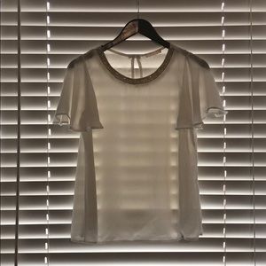 White blouse with gold accent